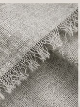 Scrunched Gray Hour scarf held in the palm of a hand